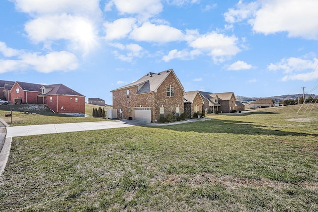 traditional-style home featuring a garage, a front yard, brick siding, and driveway