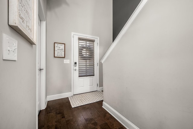 entryway with baseboards and dark wood-style flooring