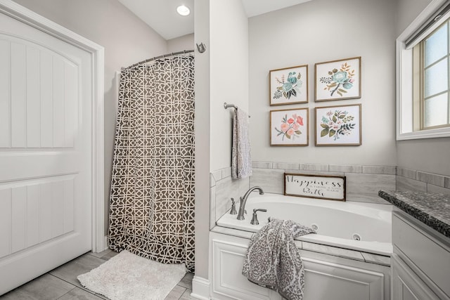 full bathroom with a jetted tub, curtained shower, tile patterned floors, and vanity