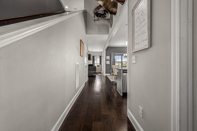 hallway featuring visible vents, baseboards, and dark wood-style flooring