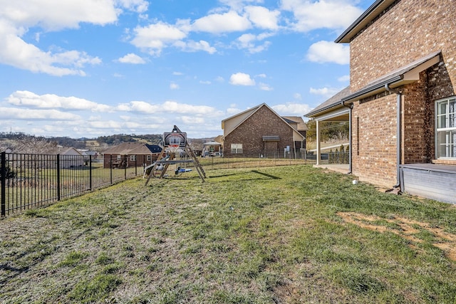 view of yard with a fenced backyard and a playground