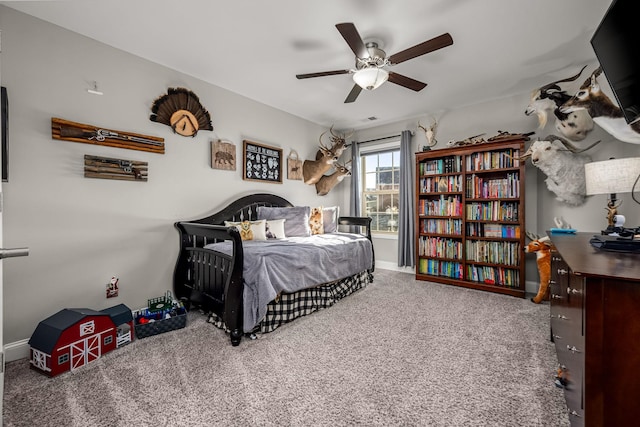 carpeted bedroom featuring a ceiling fan and baseboards