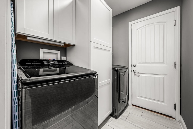 washroom with cabinet space and washing machine and clothes dryer