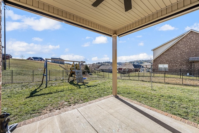 view of yard with a patio area, a playground, a fenced backyard, and ceiling fan