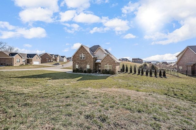 view of yard featuring fence and a residential view