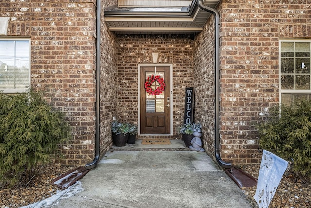 property entrance featuring brick siding