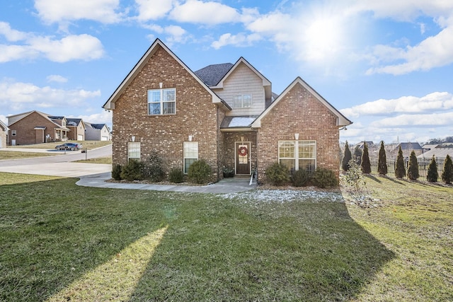 traditional home featuring a residential view, a front lawn, and brick siding