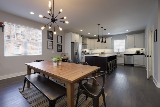 dining area featuring a chandelier, recessed lighting, dark wood-style flooring, and baseboards