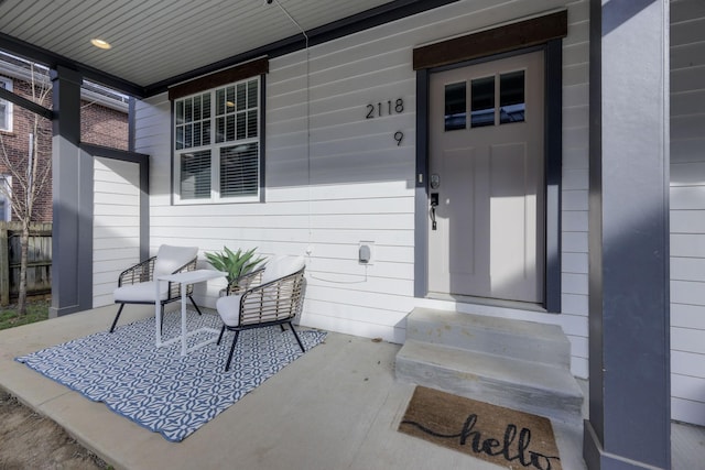 view of exterior entry with covered porch