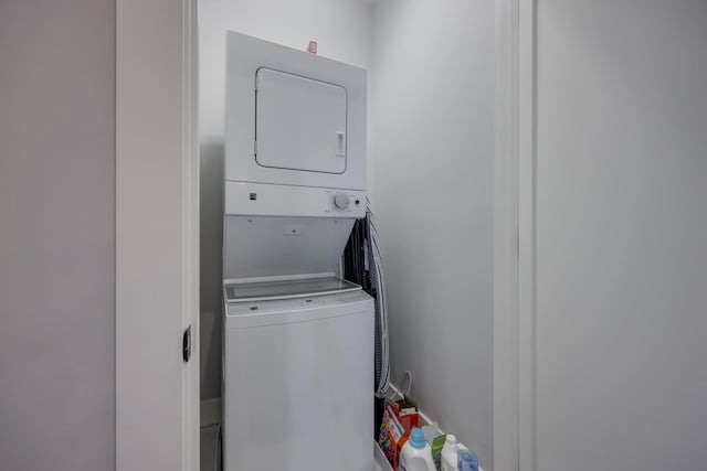 laundry room with stacked washing maching and dryer and laundry area