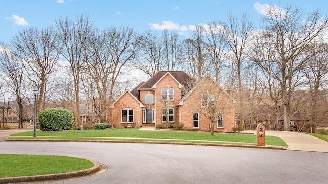 view of front of property with brick siding and a front yard