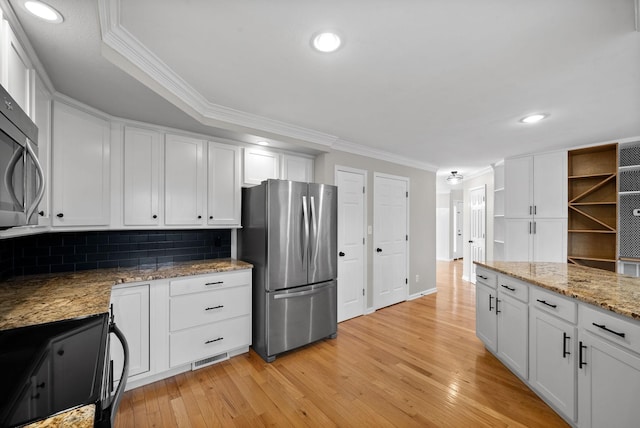 kitchen featuring white cabinetry, stainless steel appliances, and ornamental molding