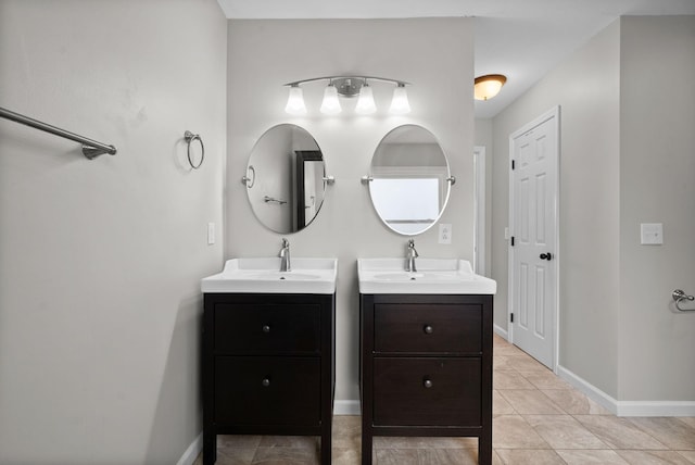 full bathroom featuring two vanities, a sink, baseboards, and tile patterned floors