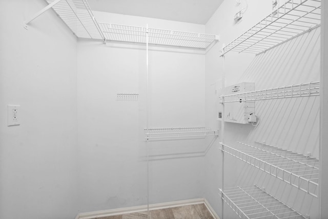 spacious closet with wood finished floors