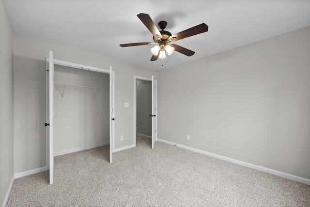 unfurnished bedroom with a ceiling fan, a closet, light colored carpet, and baseboards