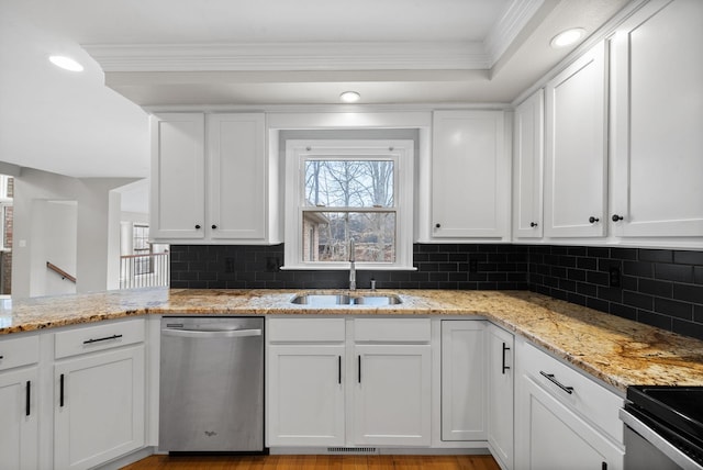 kitchen with a sink, light stone countertops, white cabinets, and dishwasher