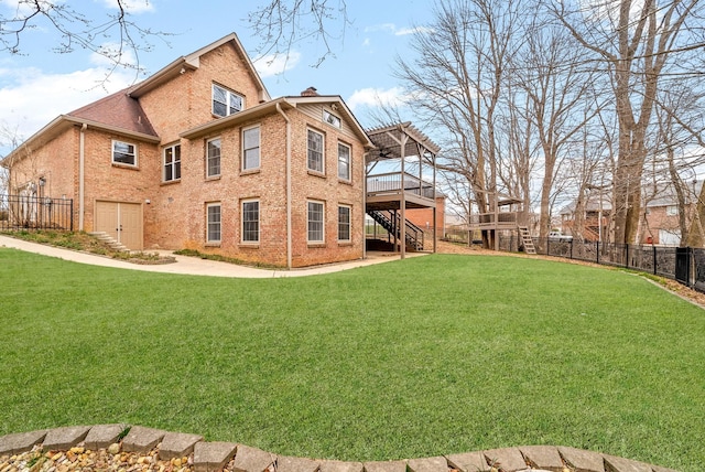 back of house with brick siding, fence, a yard, stairway, and a pergola