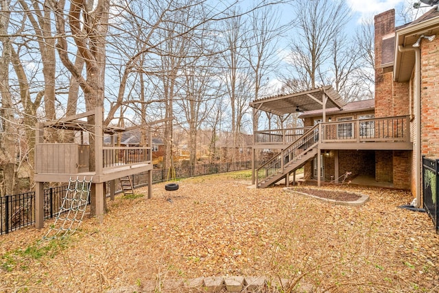 view of yard featuring a fenced backyard, stairway, a wooden deck, and a pergola