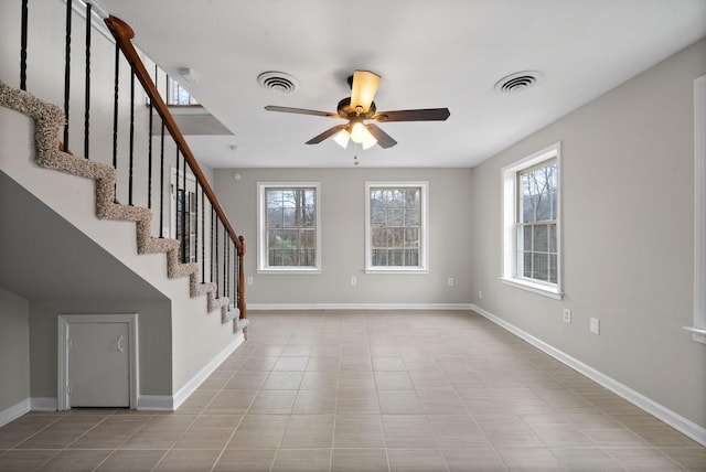 entrance foyer featuring ceiling fan, stairway, visible vents, and baseboards