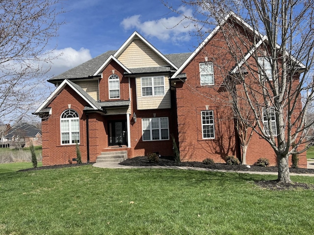 view of front of property featuring brick siding and a front yard