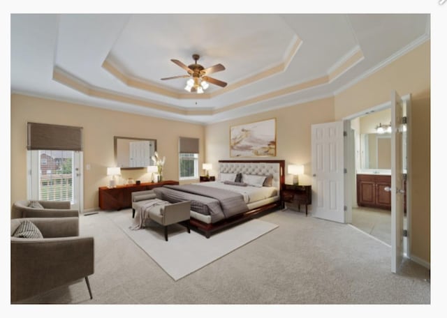 bedroom with a tray ceiling, light carpet, crown molding, and baseboards