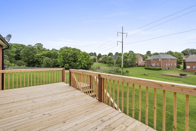 wooden deck featuring a lawn