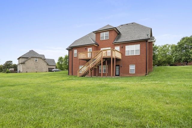 back of house featuring a deck, brick siding, stairway, and a lawn