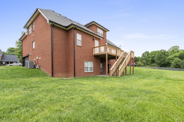 back of property with central air condition unit, stairs, a deck, and a lawn