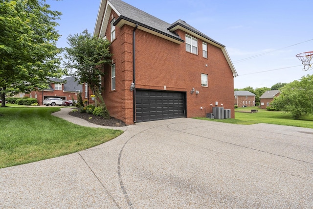 view of home's exterior with driveway, a garage, a lawn, central air condition unit, and brick siding