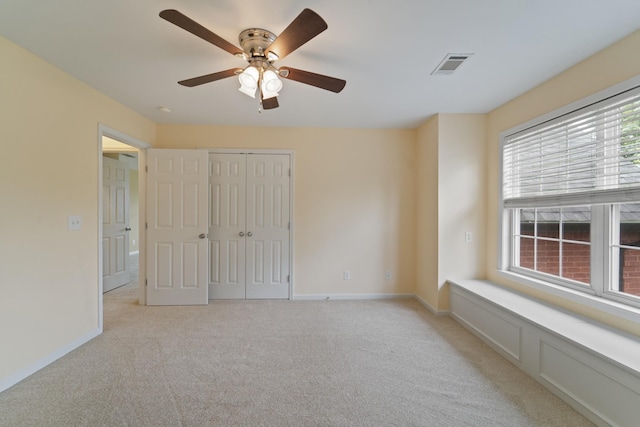 interior space featuring light carpet, a ceiling fan, visible vents, baseboards, and a closet