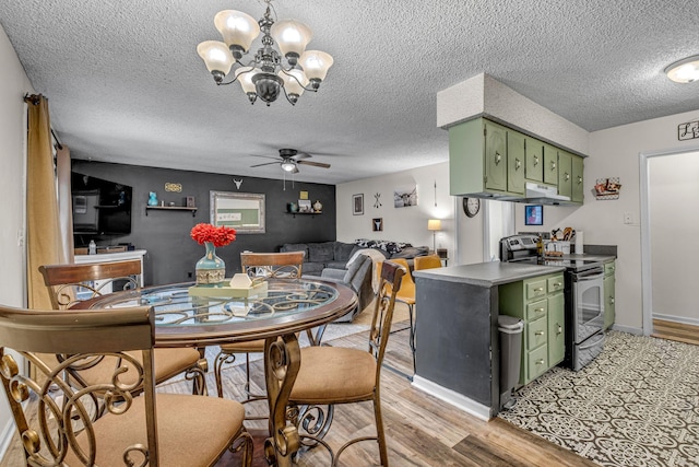 dining area featuring light wood-style flooring, baseboards, a textured ceiling, and ceiling fan with notable chandelier