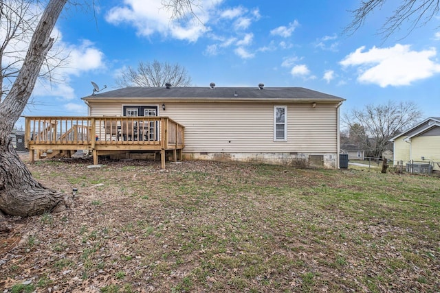 rear view of house with a deck, crawl space, and fence