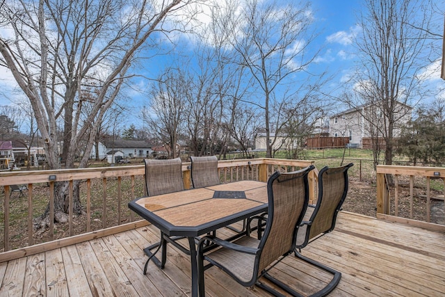 wooden deck with outdoor dining area, fence, and a residential view