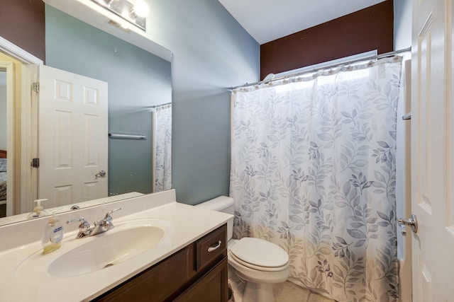 bathroom featuring toilet, tile patterned flooring, a shower with shower curtain, and vanity