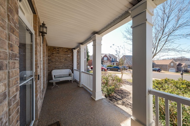 view of patio / terrace with a residential view and a porch