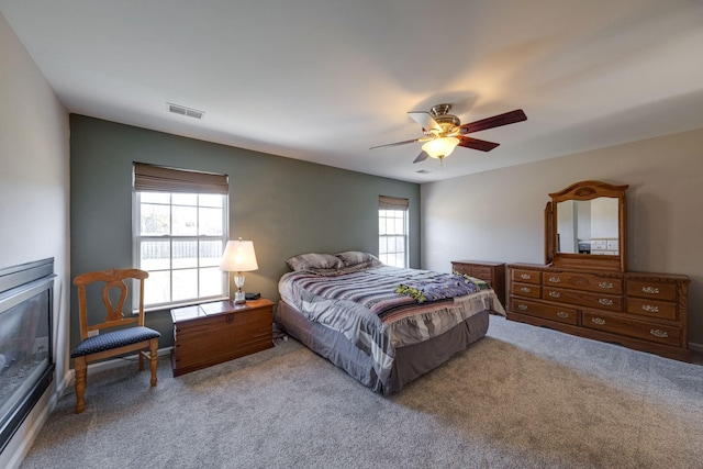 bedroom featuring a ceiling fan and carpet