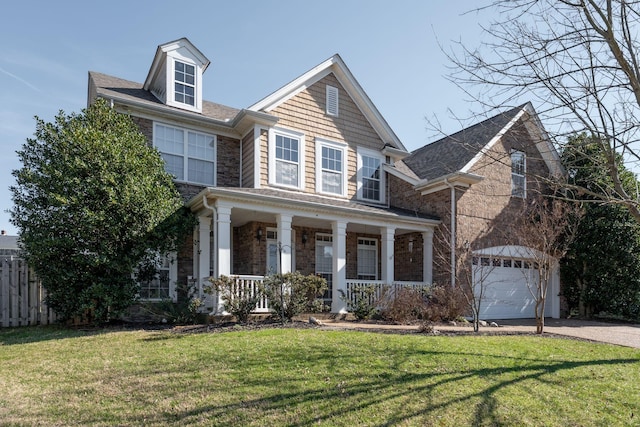 view of front of property with driveway, stone siding, an attached garage, a porch, and a front yard