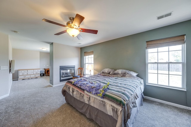 bedroom featuring light carpet, baseboards, and visible vents