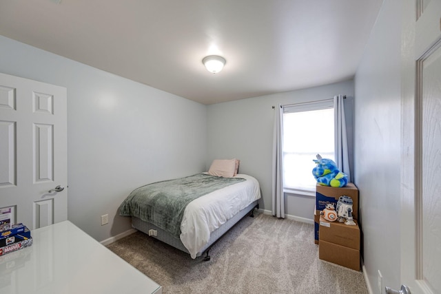 bedroom featuring carpet and baseboards