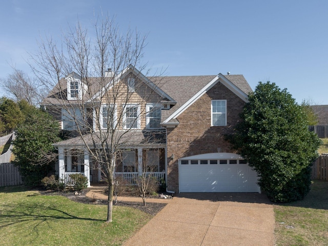 view of front of house with a garage, brick siding, fence, driveway, and a front yard