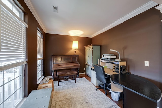 office featuring ornamental molding, visible vents, baseboards, and wood finished floors