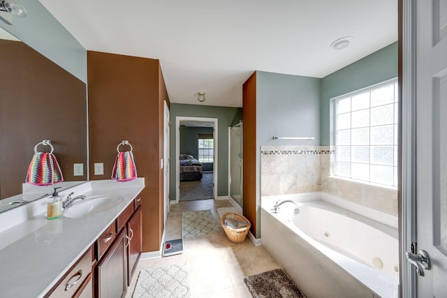 bathroom with baseboards, vanity, a whirlpool tub, and walk in shower