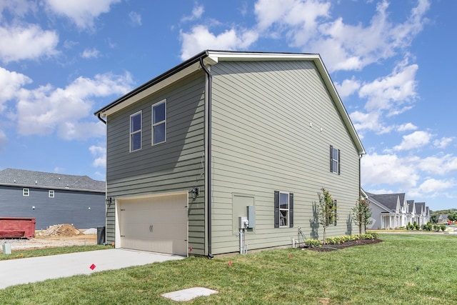 view of property exterior with a garage, a yard, and concrete driveway