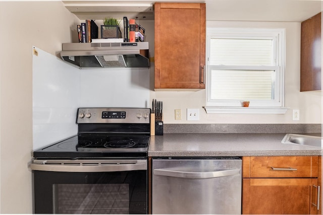 kitchen with stainless steel appliances, brown cabinetry, and under cabinet range hood