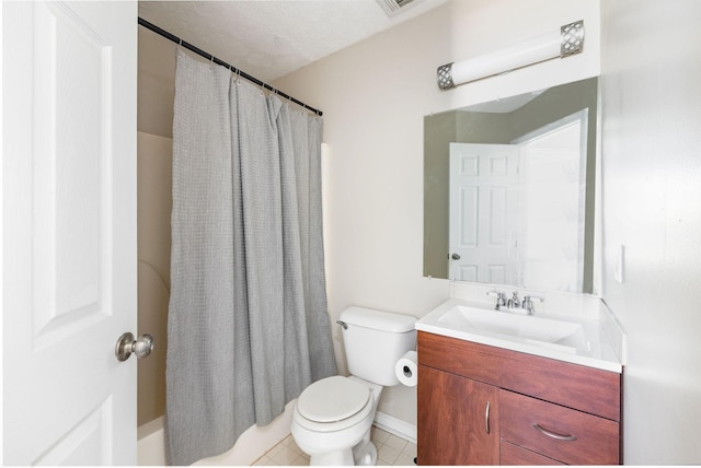 bathroom featuring toilet, vanity, and tile patterned floors