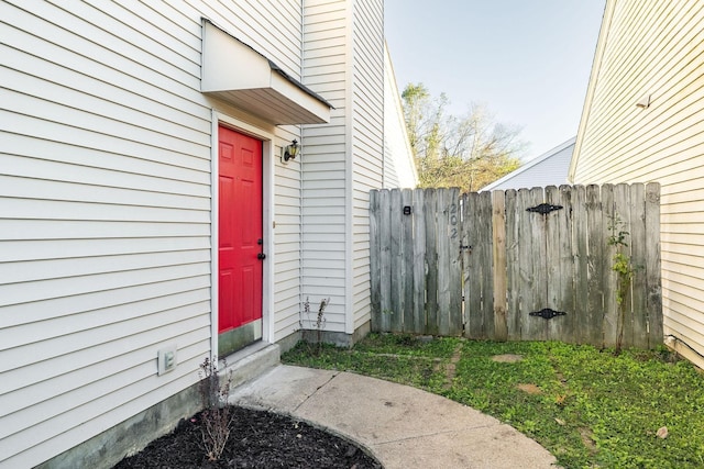 view of exterior entry with a gate and fence