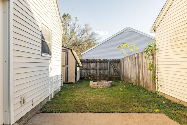 view of yard with a fenced backyard and a fire pit