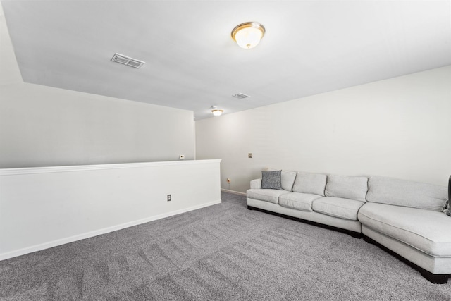 unfurnished living room featuring carpet floors, visible vents, and baseboards