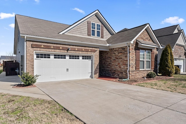 view of front of house featuring driveway, stone siding, and brick siding