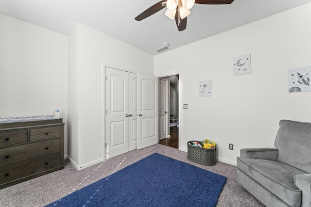 sitting room with a ceiling fan, carpet, visible vents, and baseboards